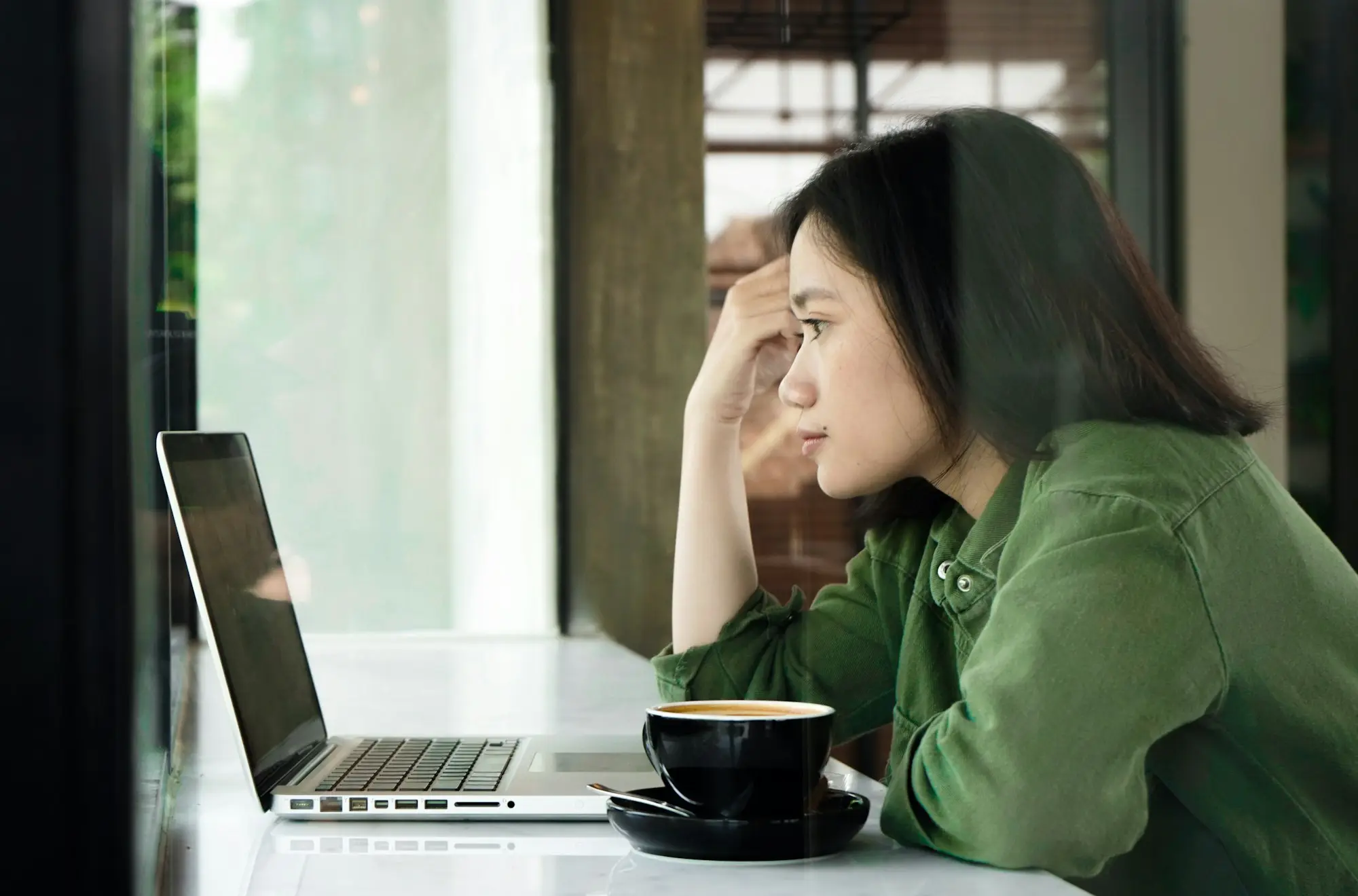 Woman working late on a laptop at a table